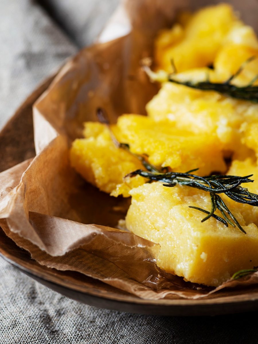 Typical Italian fried polenta with rosemary, selective focus, square image